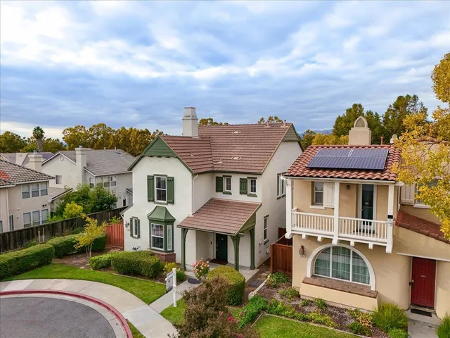 an aerial view of a house with a yard