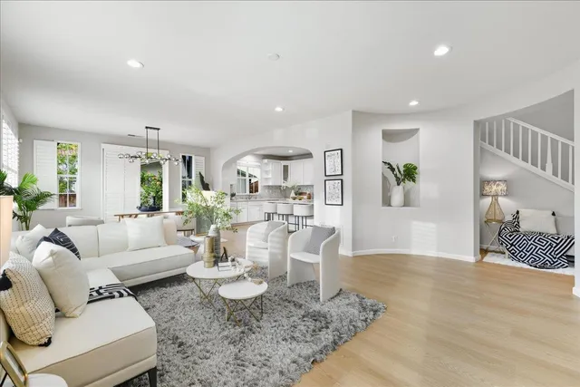 a living room with furniture a fireplace and a potted plant