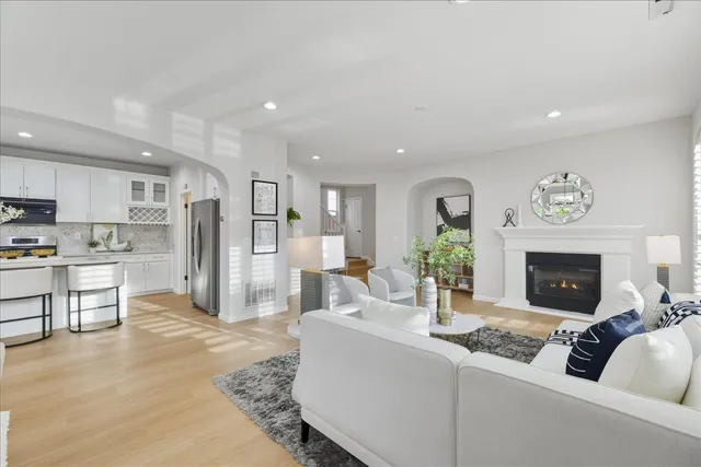a living room with furniture a chandelier and a dining table