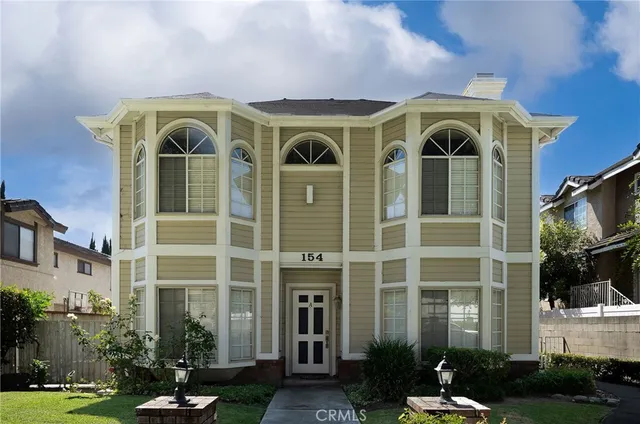a front view of a residential apartment building with a yard