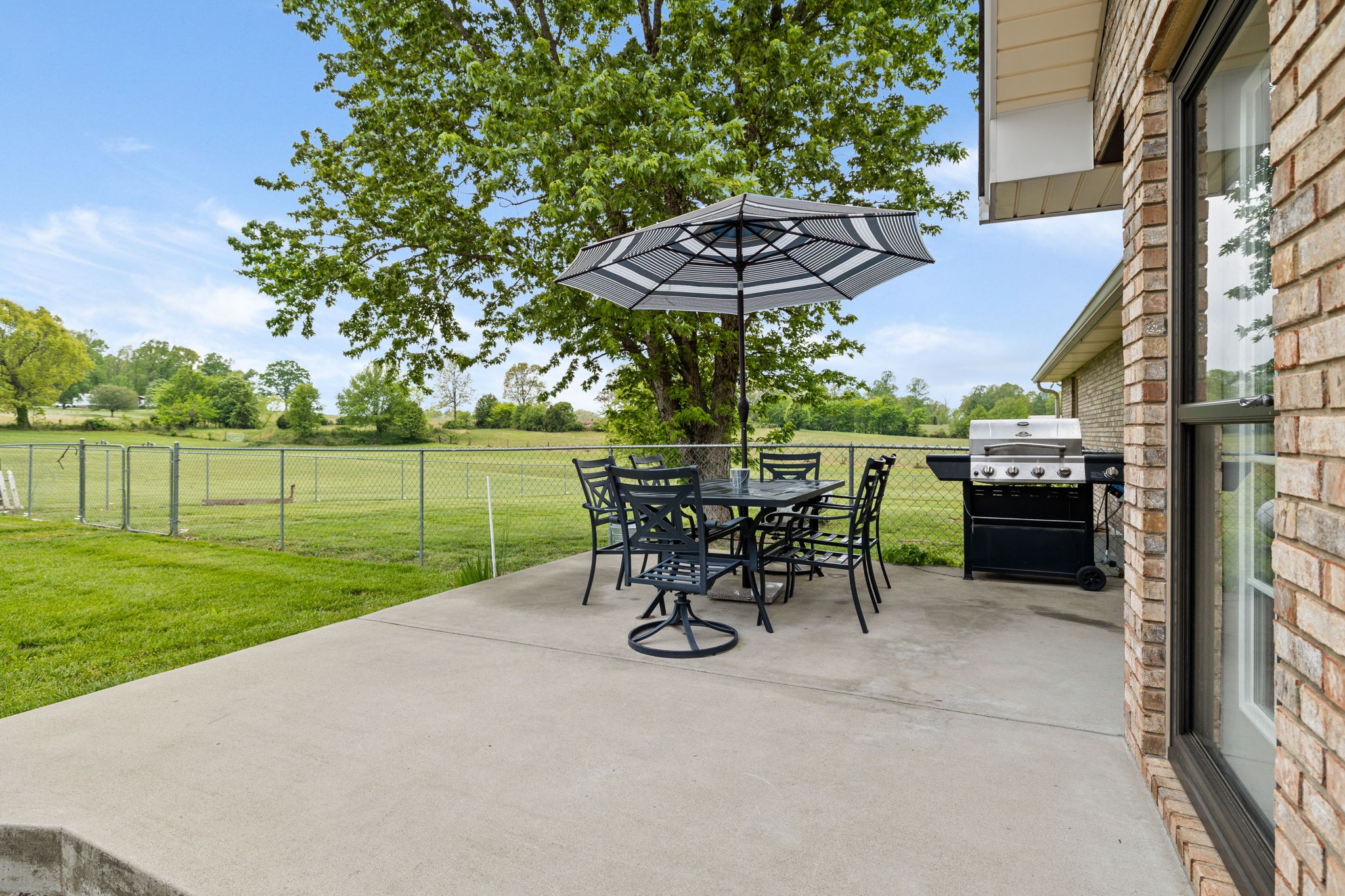 188 Switchboard Road Portland, TN 37148 - Photo 34 of 48 a view of a patio with a table chairs and a garden