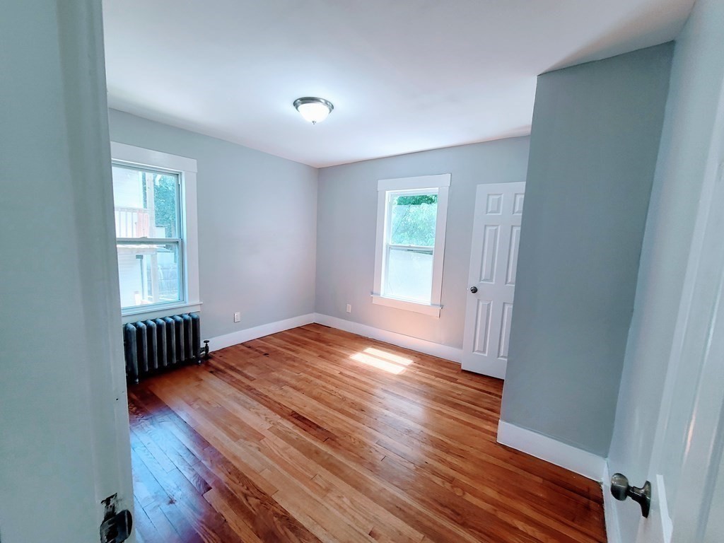 33-35 Algonquin Place Springfield, MA 01104 - Photo 7 of 10 a view of an empty room with wooden floor and a window