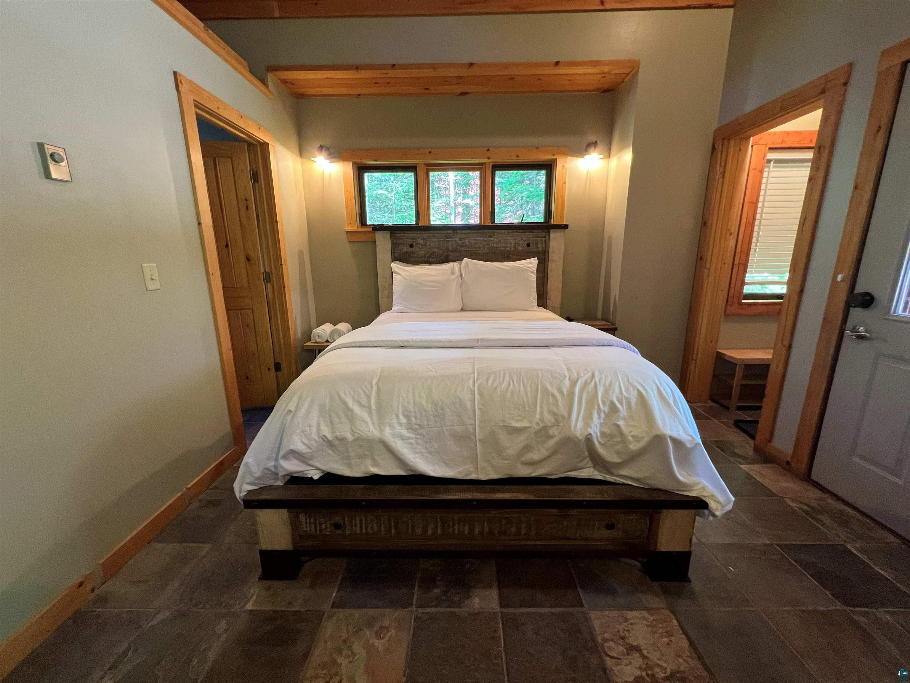 87645 Bjorn Road Bayfield, WI 54814 - Photo 12 of 13 Bedroom featuring dark stone finish floors