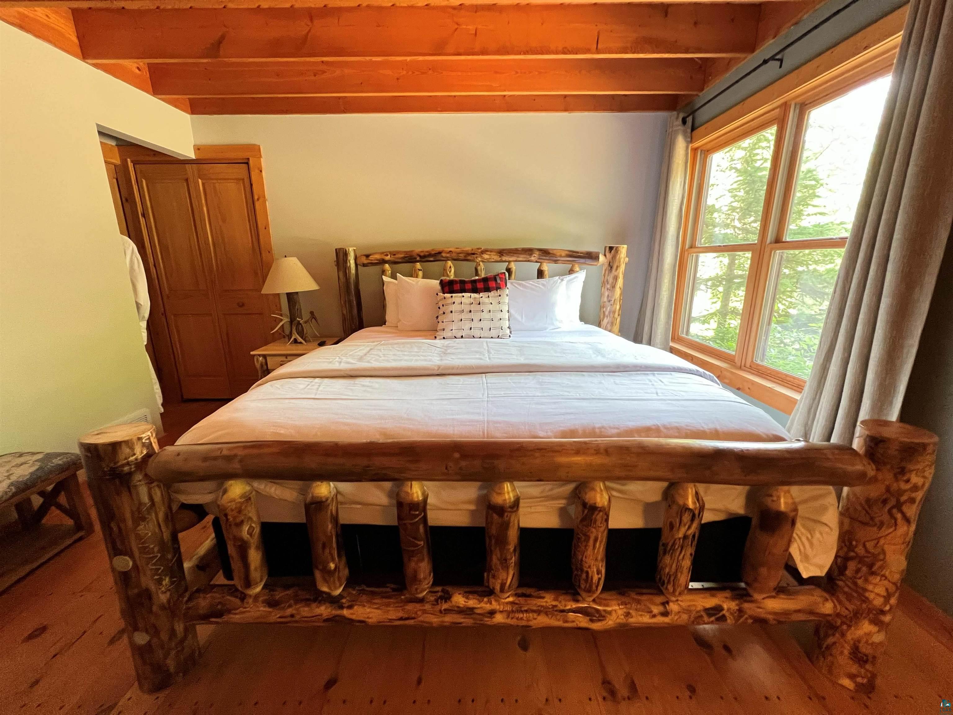 87645 Bjorn Road Bayfield, WI 54814 - Photo 5 of 13 Bedroom featuring wood finished floors and beamed ceiling