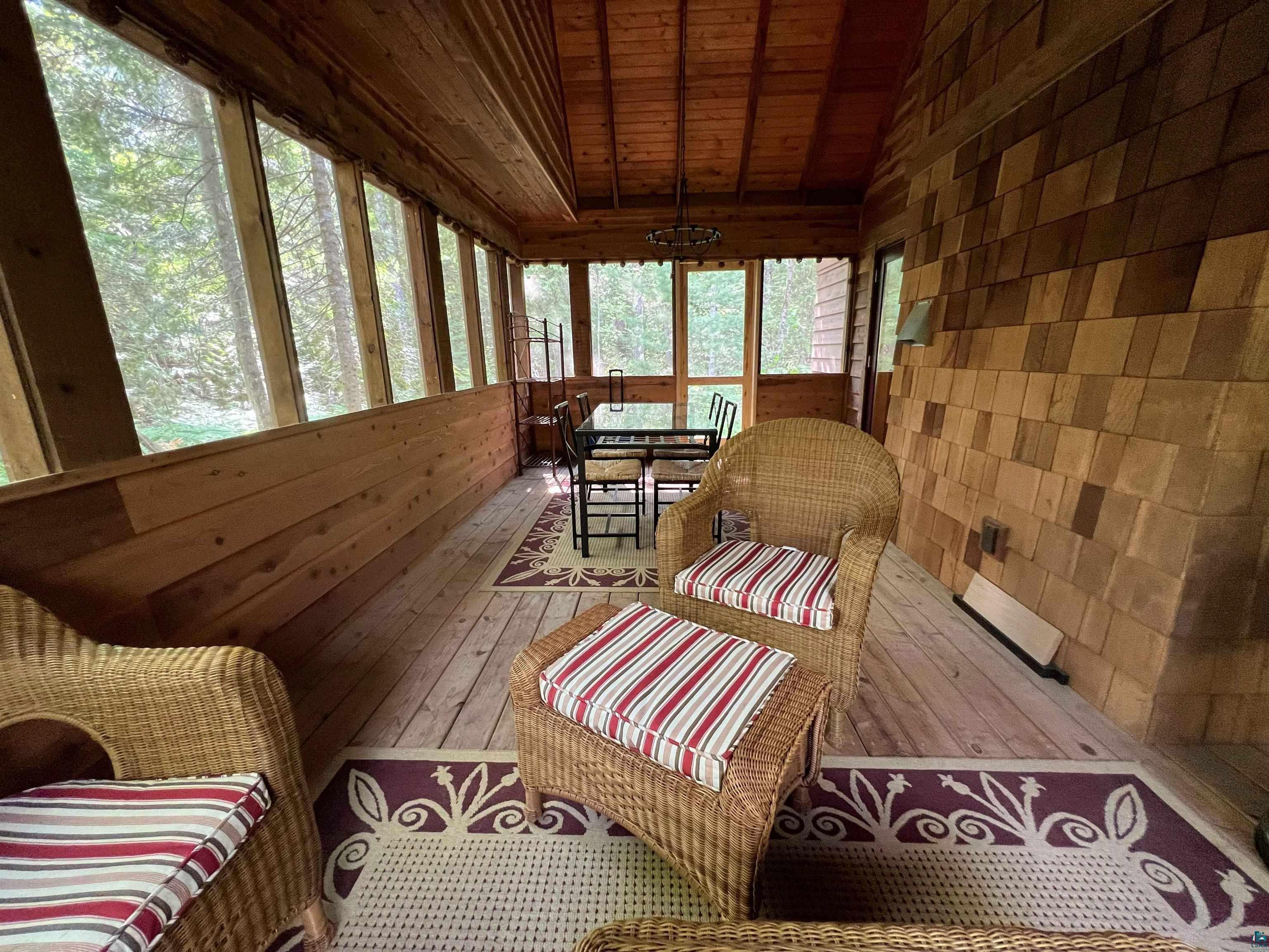 87645 Bjorn Road Bayfield, WI 54814 - Photo 10 of 13 Sunroom with a vaulted wooden ceiling, outdoor dining space, and wood walls