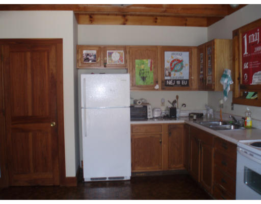 43 Taylor Hill Road Montague, MA 01351 - Photo 2 of 8 a kitchen with a sink a refrigerator and cabinets