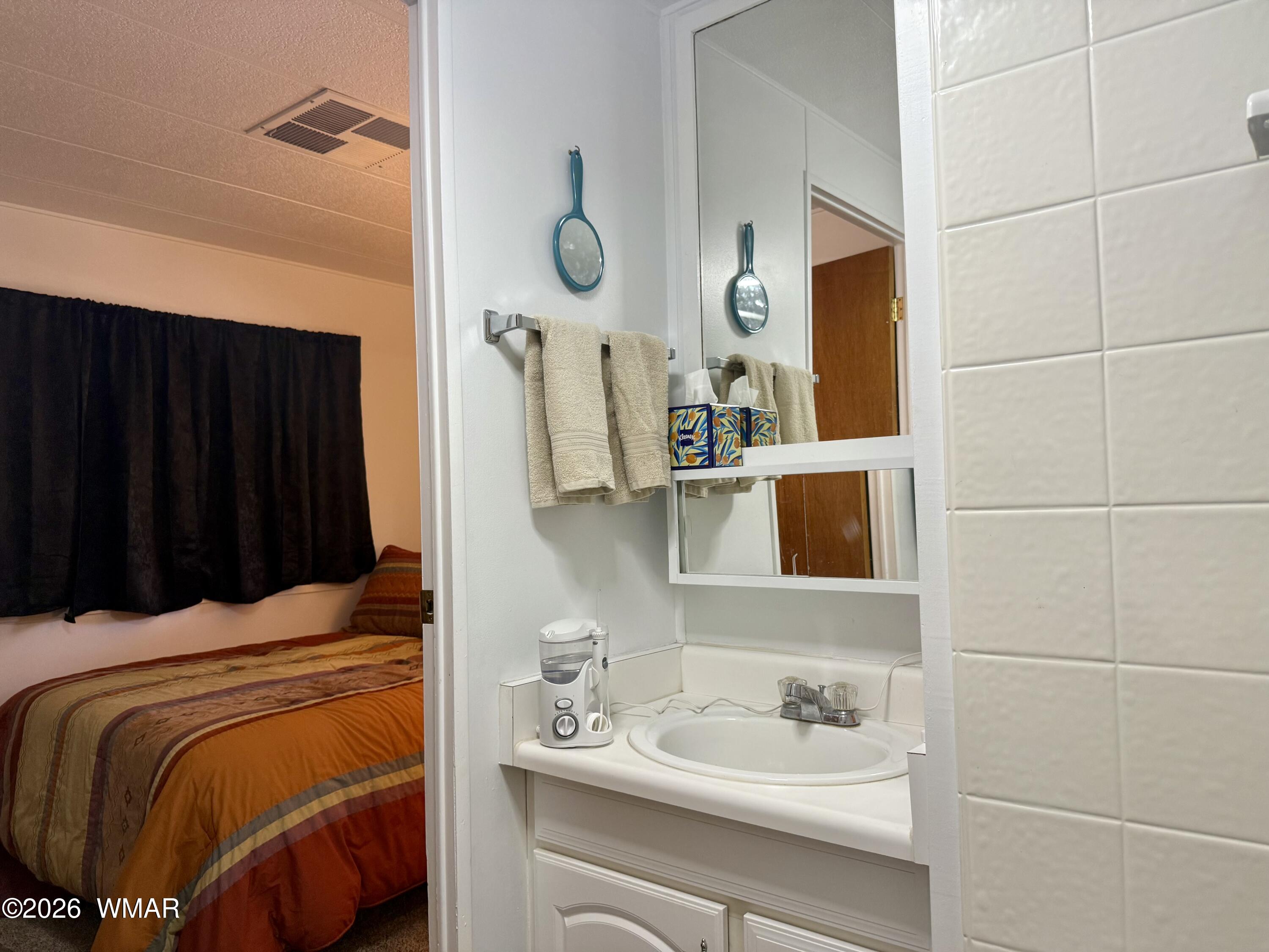727 South Butler Street Eagar, AZ 85925 - Photo 19 of 32 a bathroom with a sink and a mirror