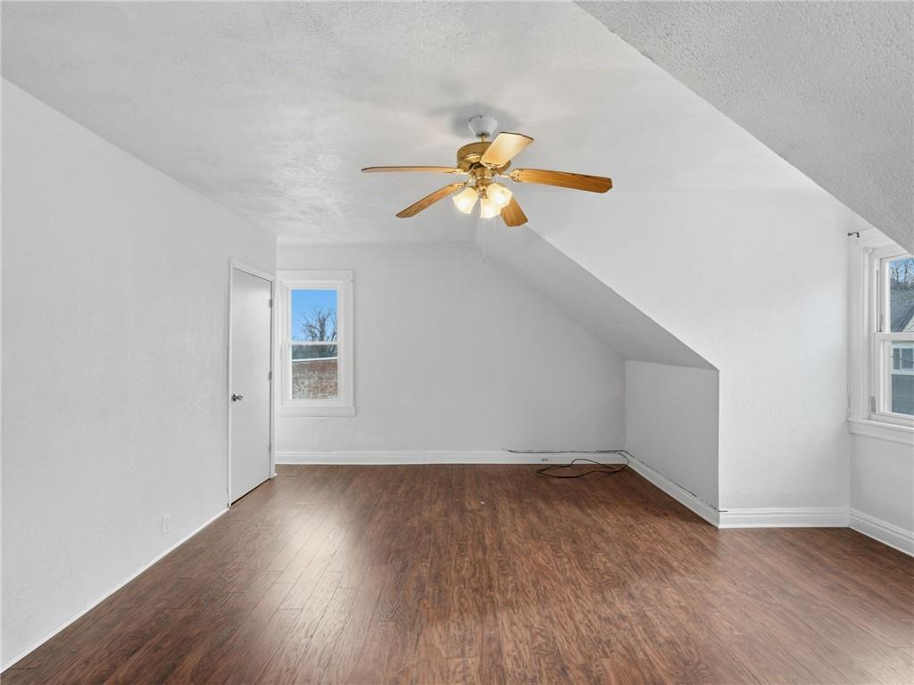 7307 Butler Street Pittsburgh, PA 15206 - Photo 19 of 35 an empty room with wooden floor and windows