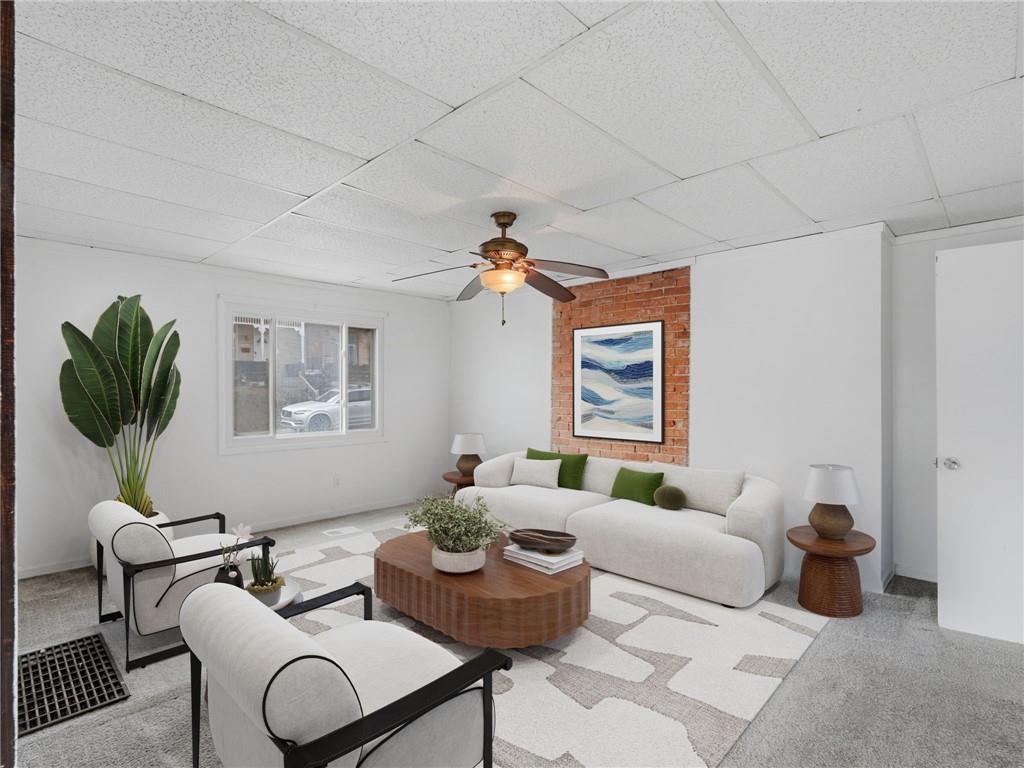 7307 Butler Street Pittsburgh, PA 15206 - Photo 3 of 35 a living room with furniture and a potted plant