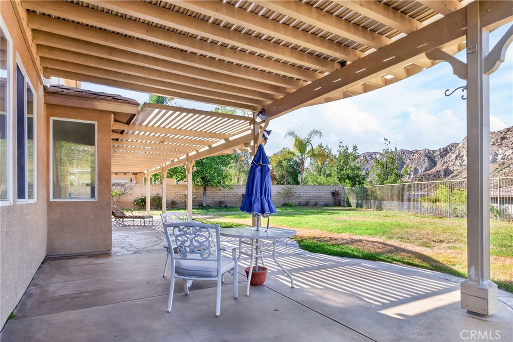 25807 Arbor Lane Stevenson Ranch, CA 91381 - Photo 54 of 65 a chair and table sitting in backyard of a house