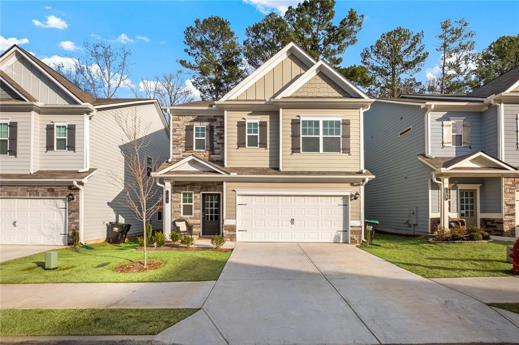 a front view of a house with a yard and garage