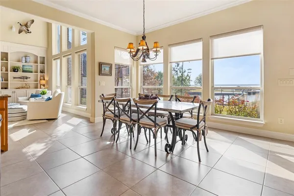 a view of a dining room with furniture large windows and wooden floor
