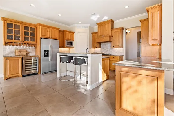 a kitchen with appliances cabinets and furniture