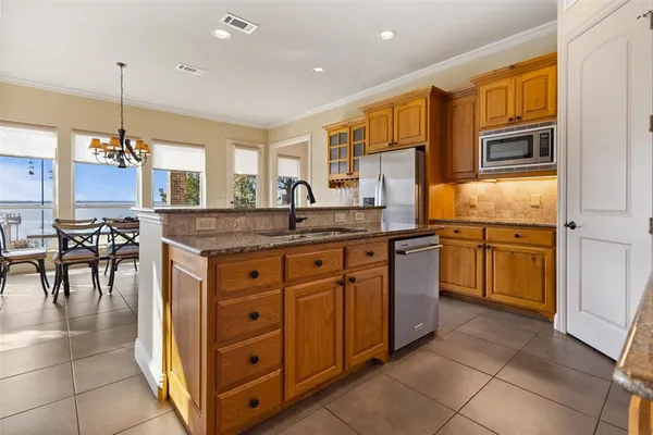 a kitchen with a sink stove and cabinets