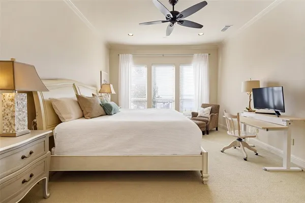 a spacious bedroom with a bed and a flat screen tv