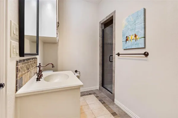 a bathroom with a sink and mirror