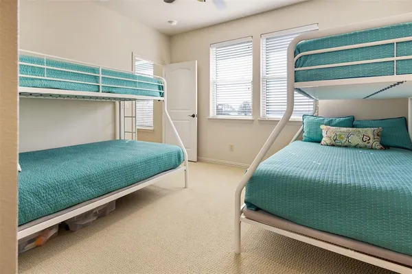 a bedroom with a bed and windows