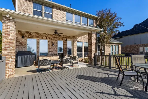 a view of a house with a deck and furniture