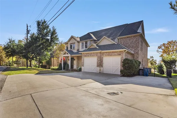 a view of a house with a yard and garage