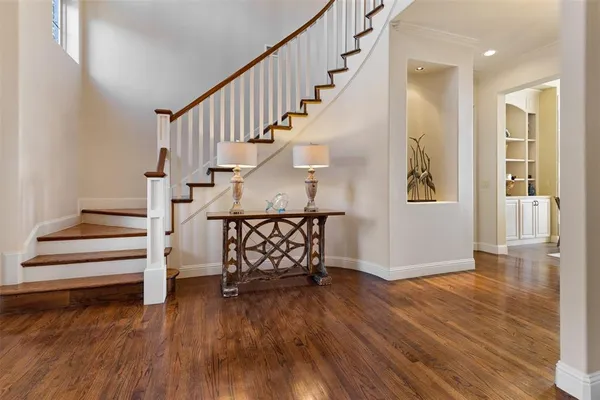 a view of entryway with wooden floor and stairs