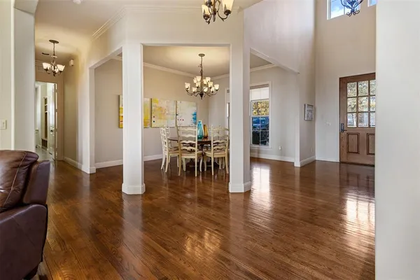 a view of a livingroom with furniture wooden floor and a chandelier