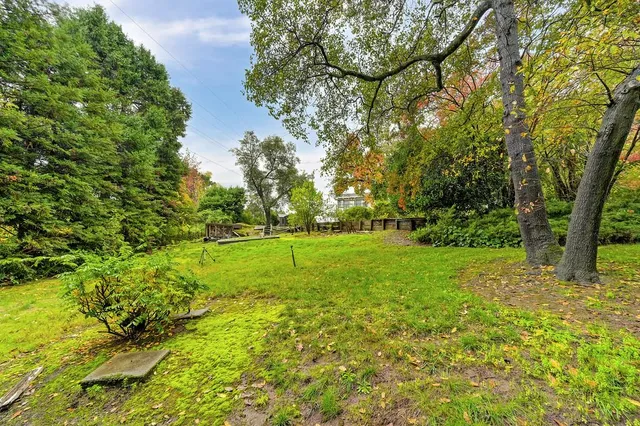 a view of a livingroom with a fireplace a chandelier and stairs