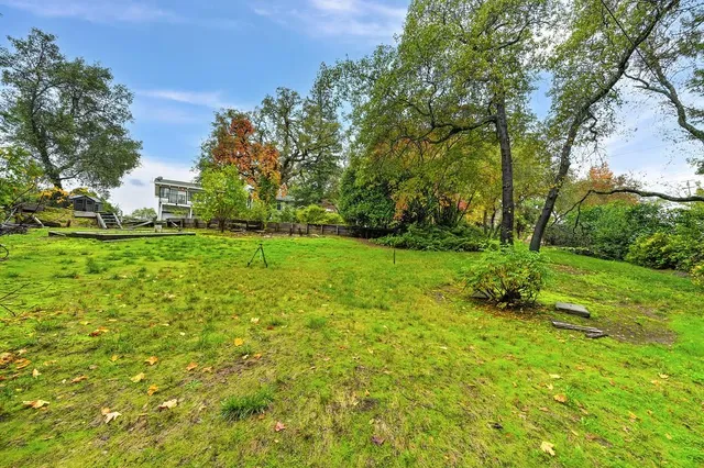 a view of empty room with wooden floor and windows