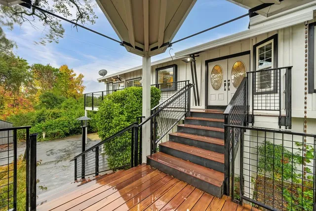 a view of balcony with wooden floor and fence