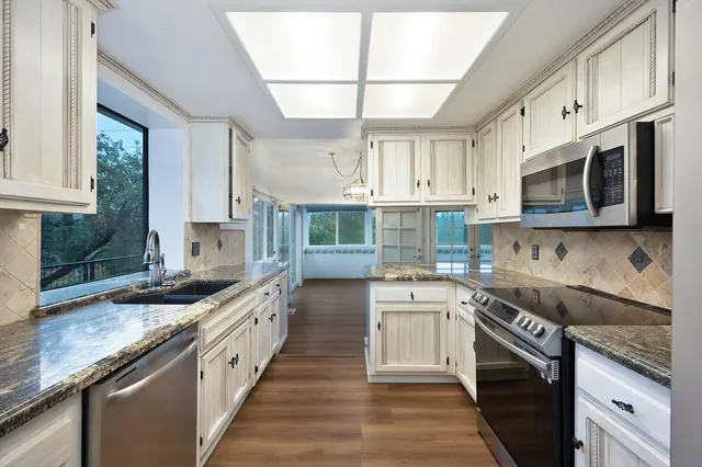 a large bathroom with a sink mirror and a bathtub