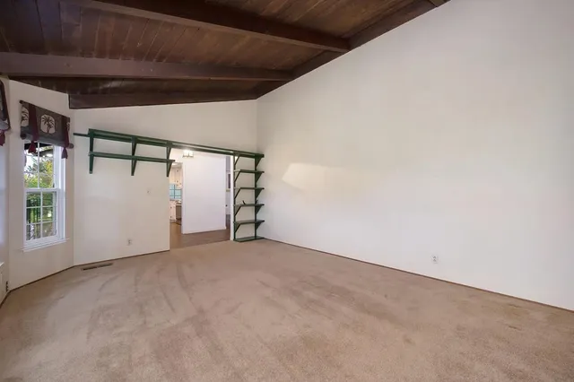 a view of a house with a yard and large trees