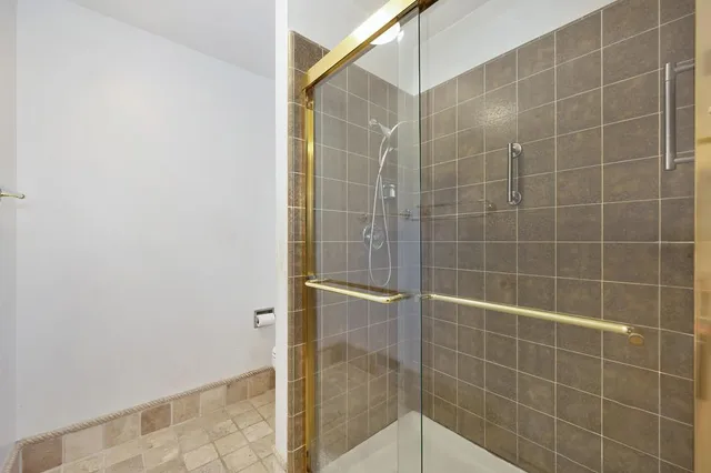an aerial view of a houses with a lush green hillside