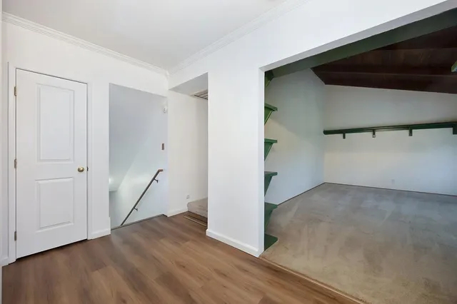 an aerial view of house with yard and mountain view in back