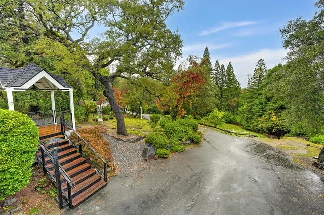 a view of a balcony with wooden floor and fence