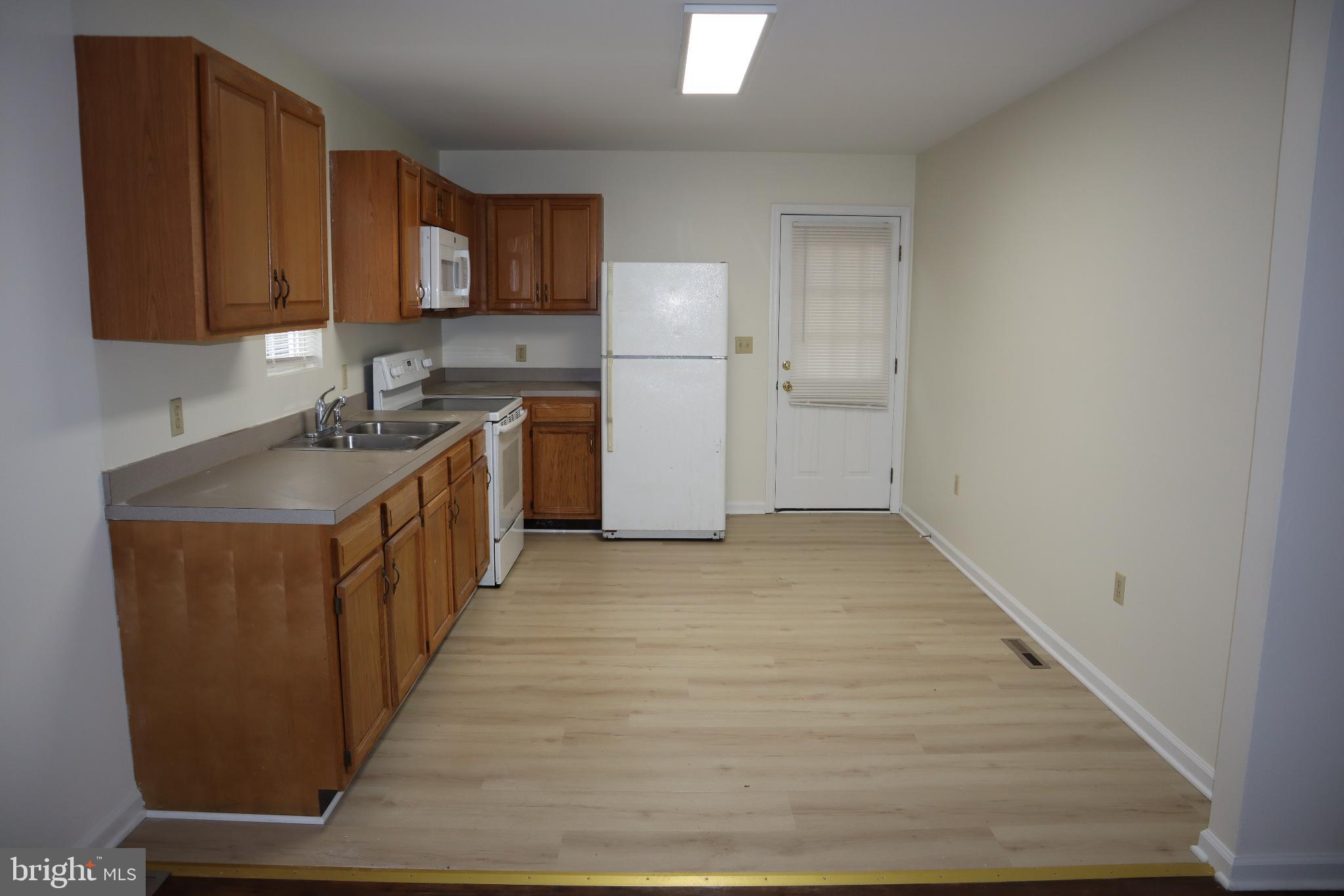 309 Decatur Avenue Salisbury, MD 21804 - Photo 4 of 15 a kitchen with sink a refrigerator and cabinets