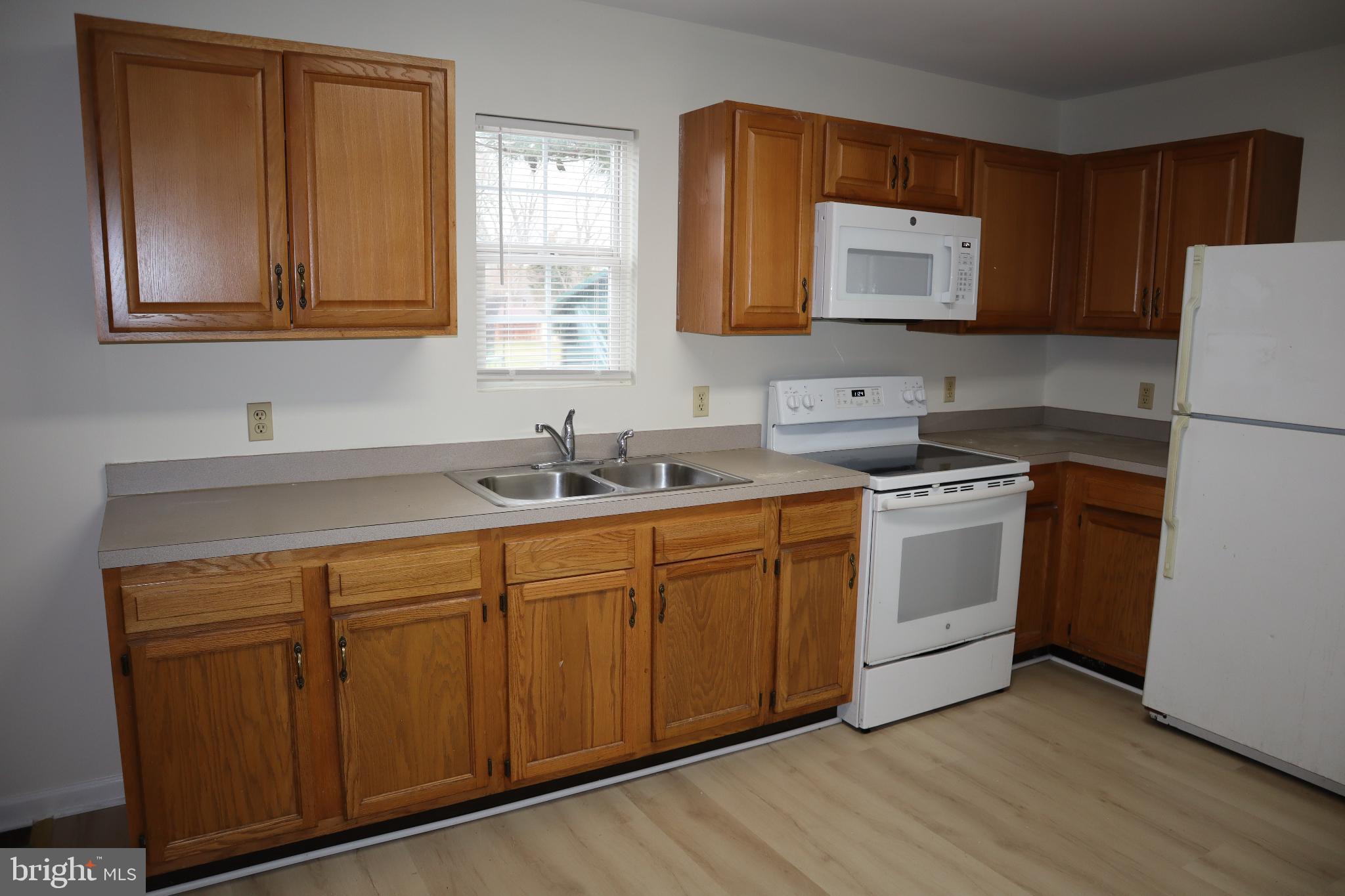 309 Decatur Avenue Salisbury, MD 21804 - Photo 5 of 15 a kitchen with sink a microwave and white cabinets