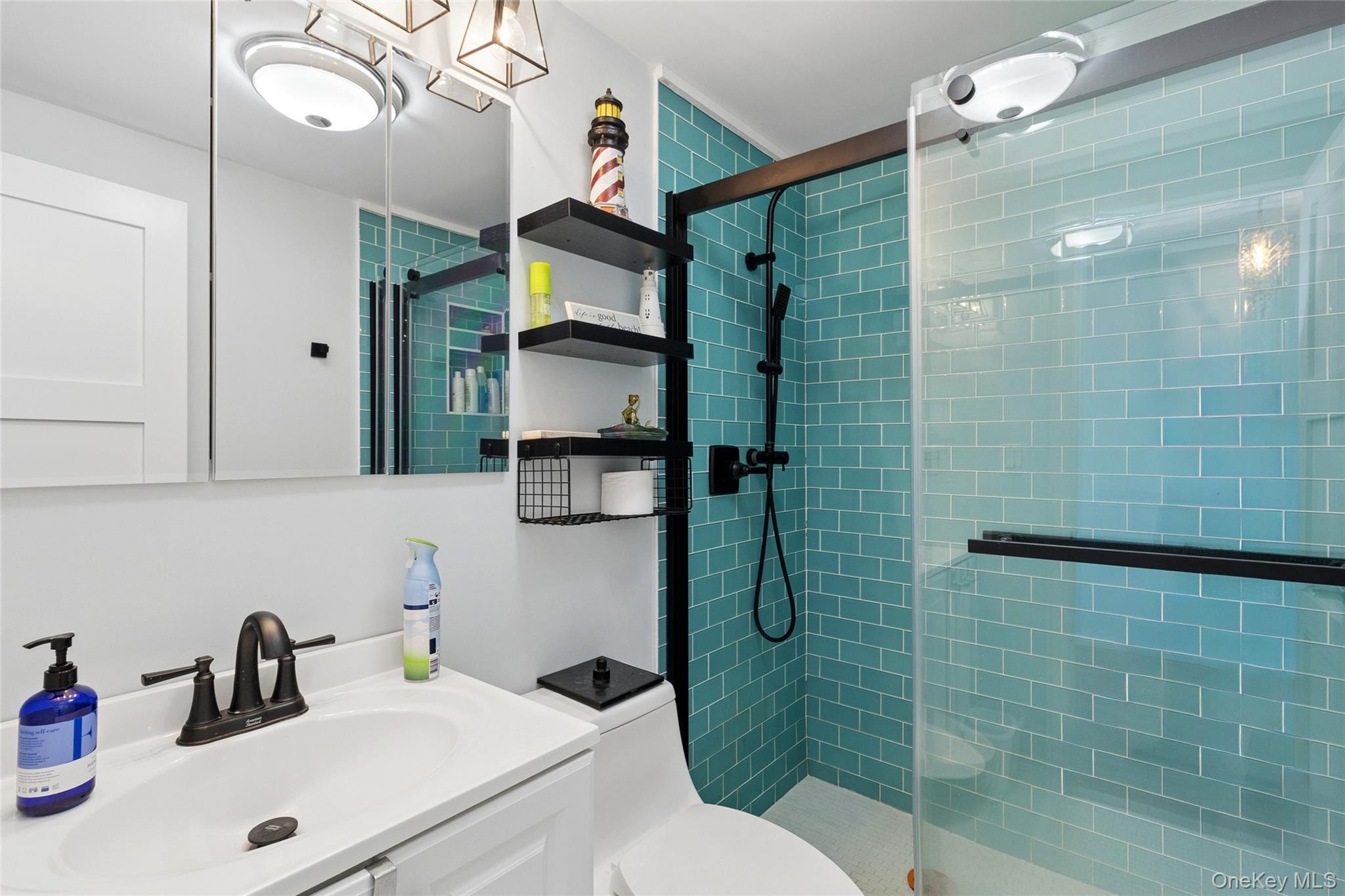 16 Navy Road, Unit 206 Montauk, NY 11954 - Photo 11 of 18 a bathroom with a sink a toilet and shower