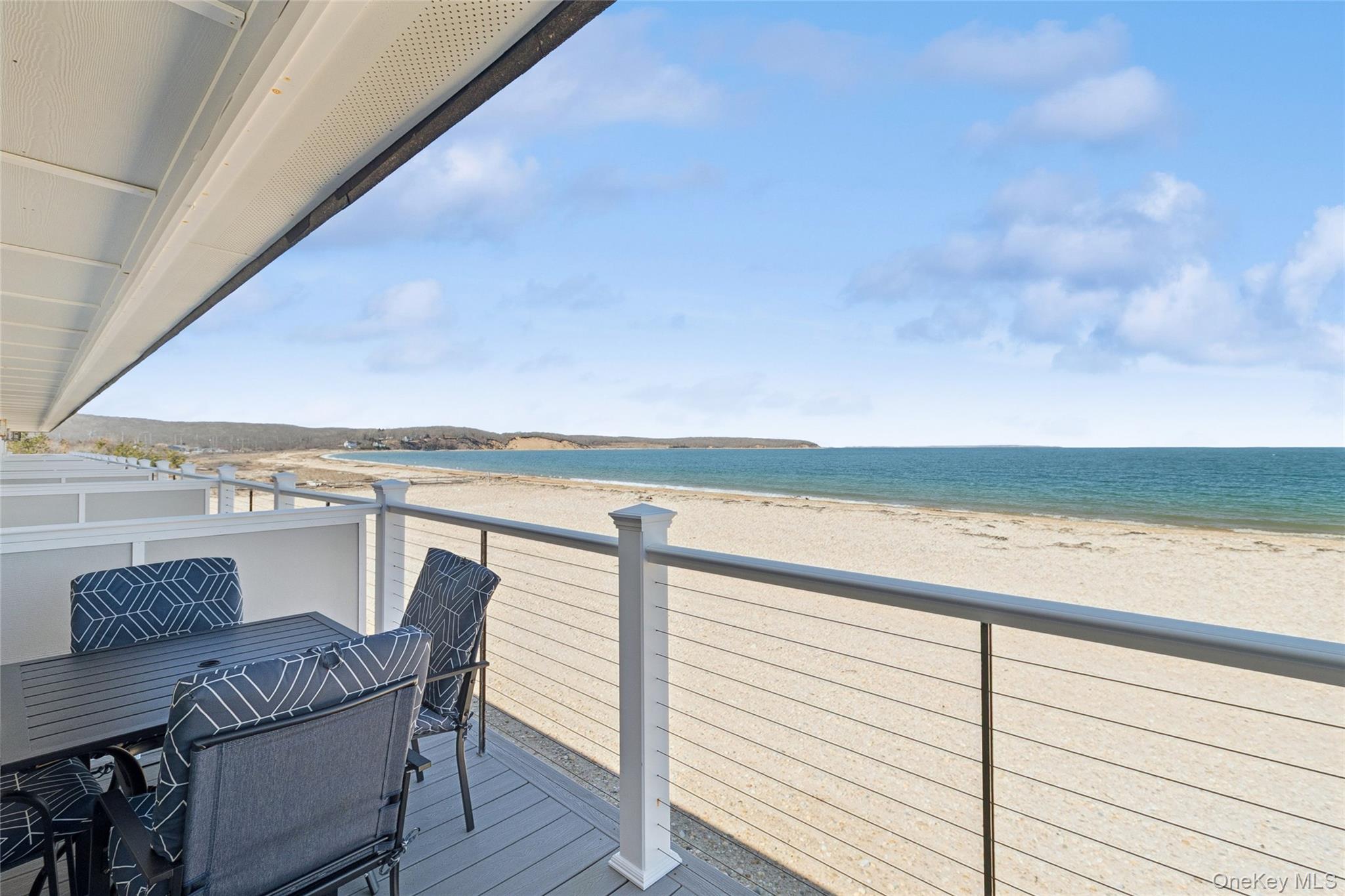 16 Navy Road, Unit 206 Montauk, NY 11954 - Photo 14 of 18 a view of a balcony with table and chairs