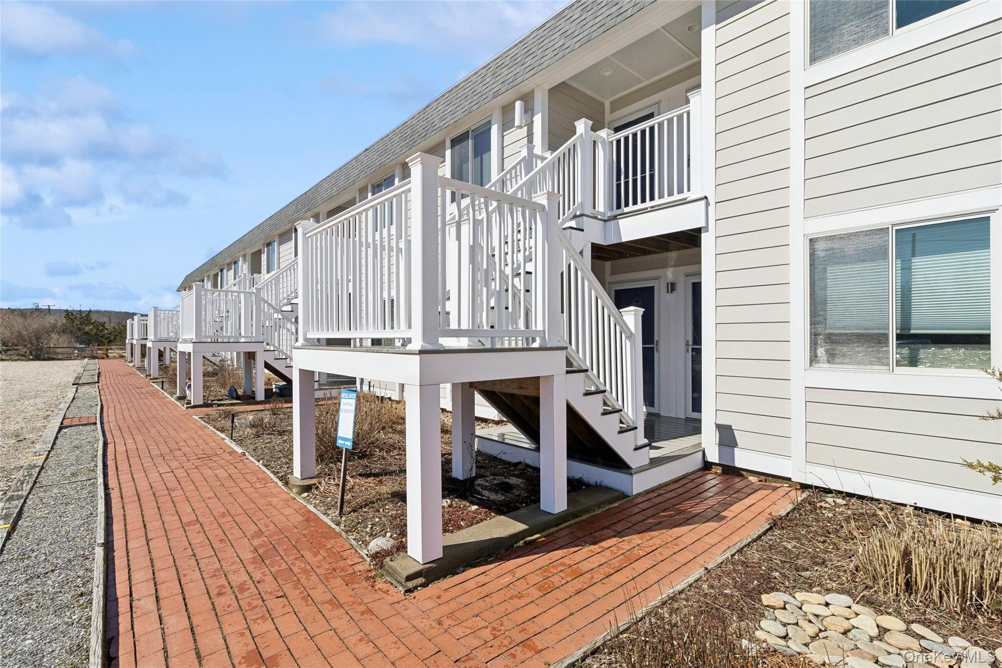 16 Navy Road, Unit 206 Montauk, NY 11954 - Photo 17 of 18 a view of a balcony with wooden floor and fence
