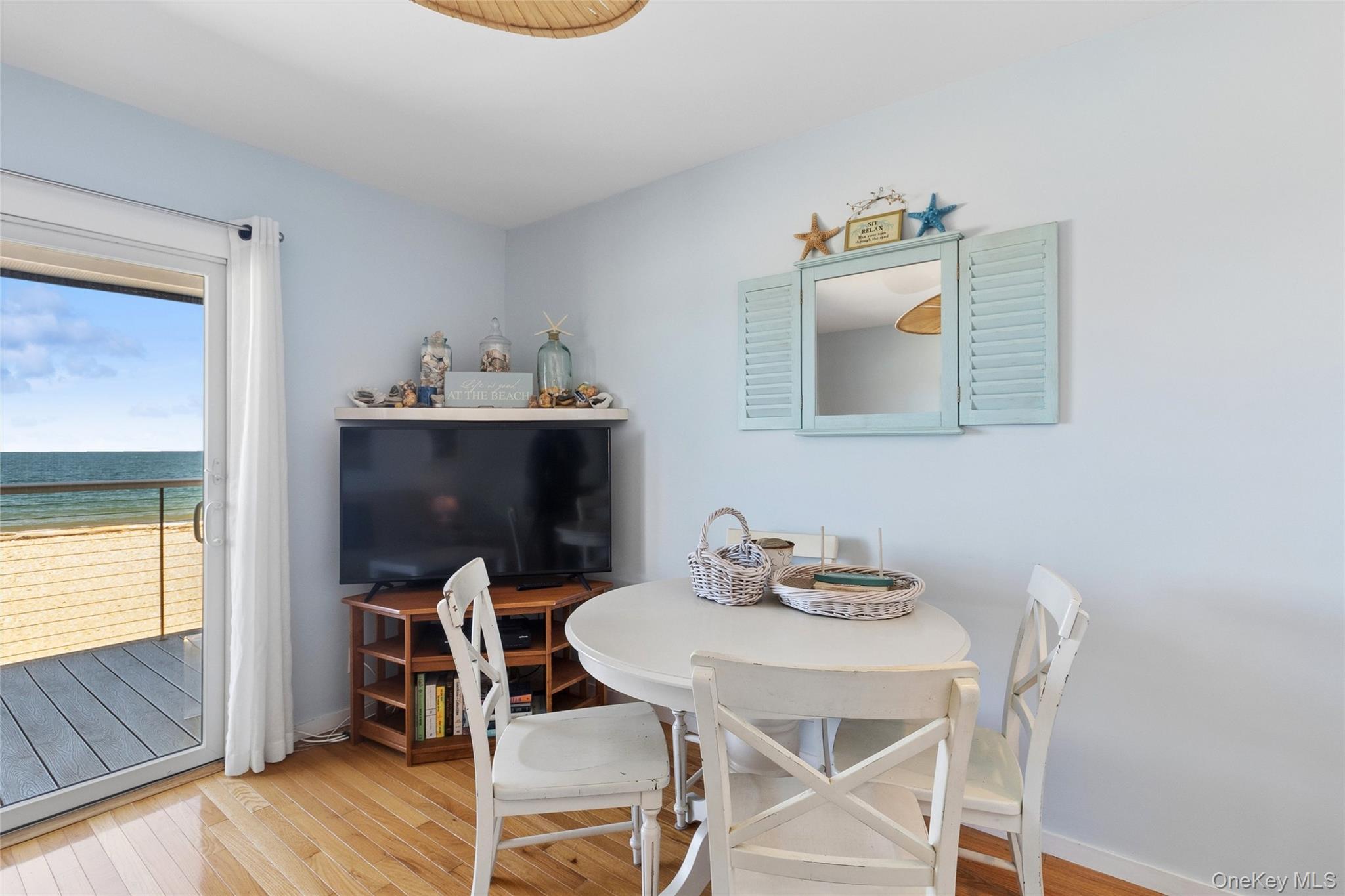 16 Navy Road, Unit 206 Montauk, NY 11954 - Photo 5 of 18 a view of a dining room with furniture and wooden floor