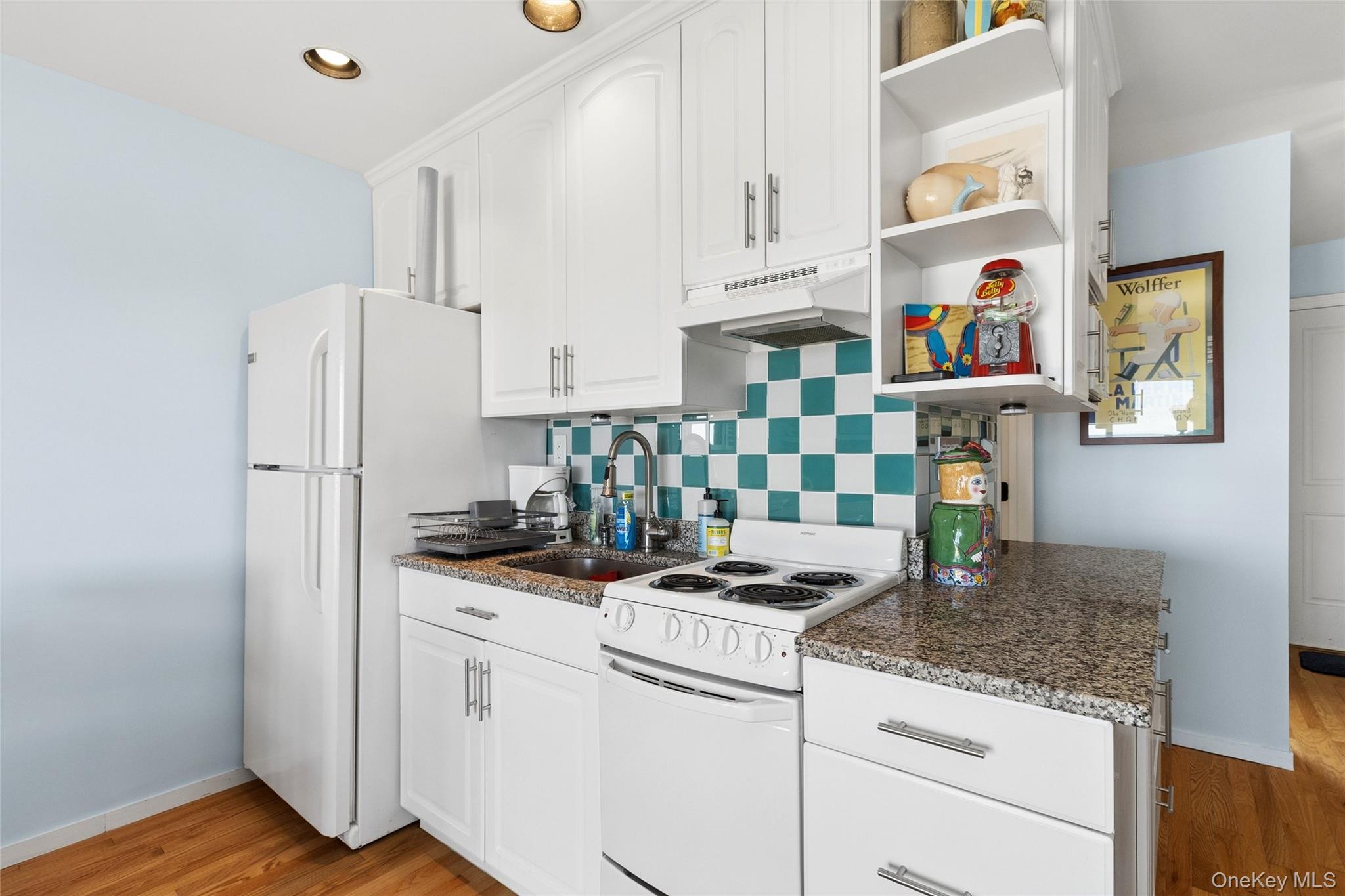 16 Navy Road, Unit 206 Montauk, NY 11954 - Photo 9 of 18 a kitchen with stainless steel appliances granite countertop a refrigerator and a stove