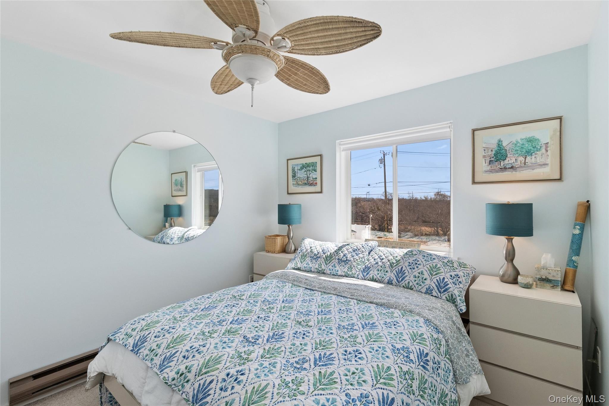 16 Navy Road, Unit 206 Montauk, NY 11954 - Photo 10 of 18 a bedroom with a large bed and a chandelier