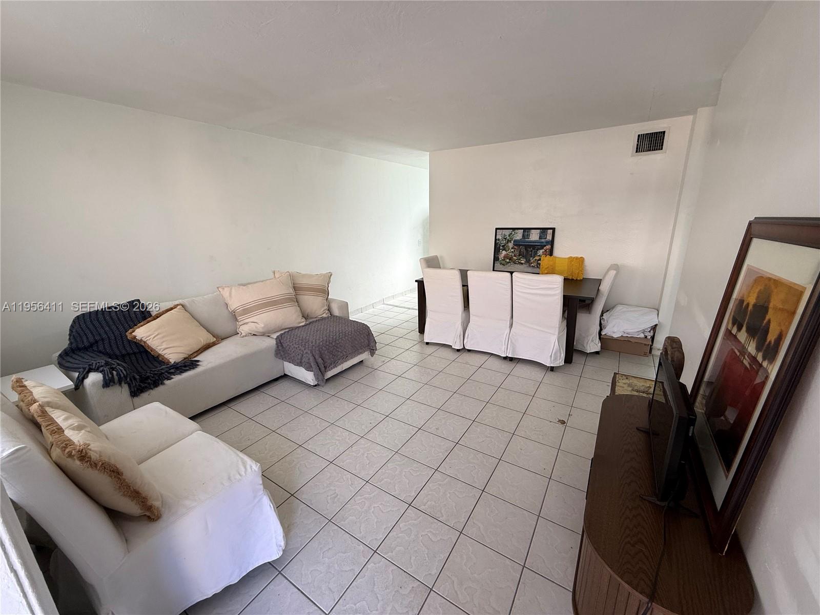 654 West 29th Street, Unit 1 Hialeah, FL 33012 - Photo 4 of 14 a living room with furniture and a couch