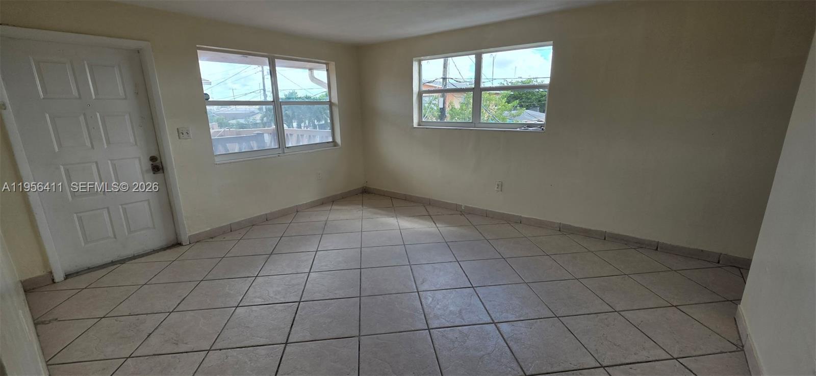 654 West 29th Street, Unit 1 Hialeah, FL 33012 - Photo 7 of 14 an empty room with windows