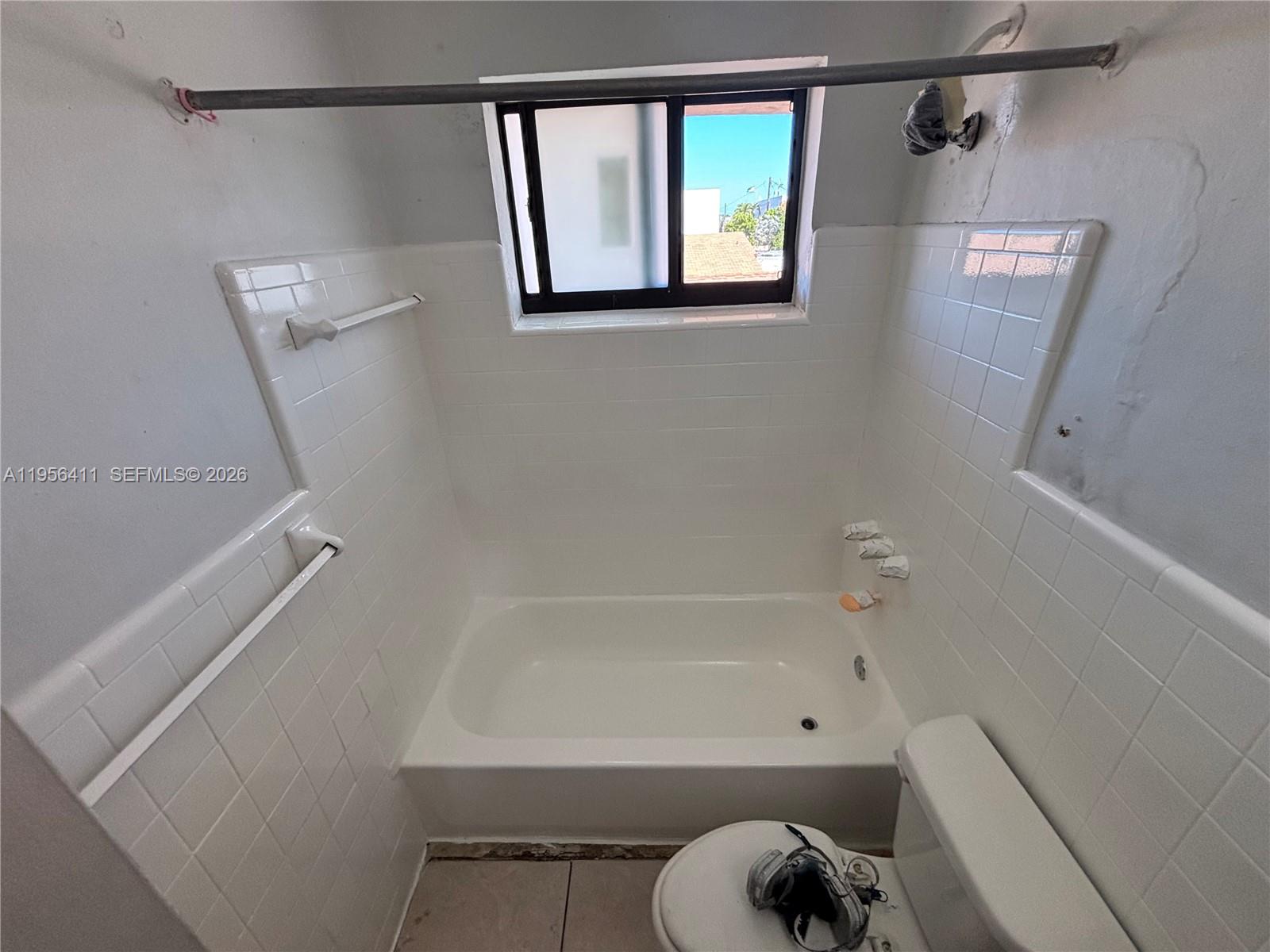 654 West 29th Street, Unit 1 Hialeah, FL 33012 - Photo 10 of 14 a bathroom with a shower and toilet