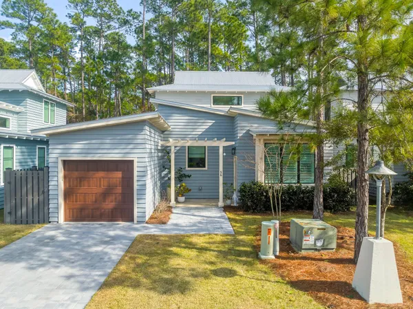 a view of a house with backyard porch and sitting area