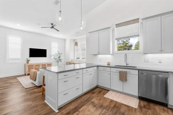 a kitchen with a sink cabinets and wooden floor