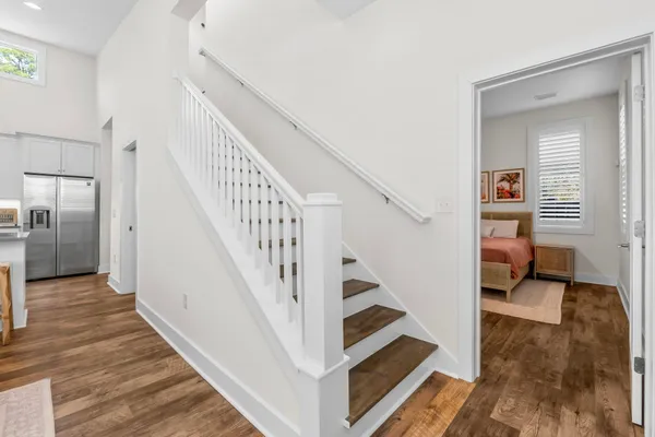 a view of entryway and hall with wooden floor