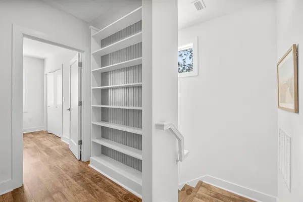 a view of a bedroom with closet and racks