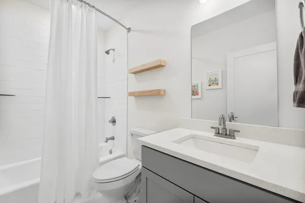 a bathroom with a sink toilet and shower