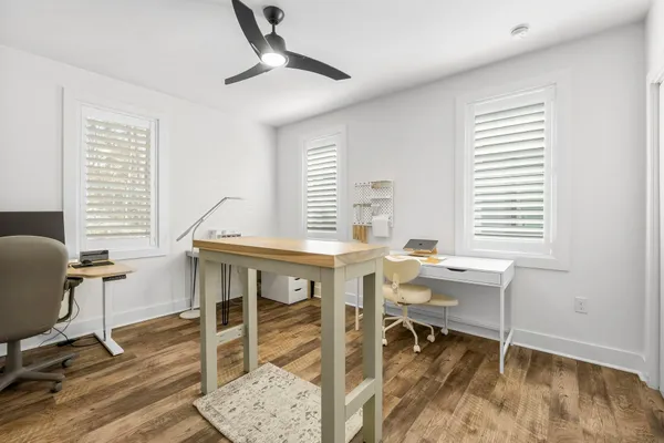 a view of a workspace with furniture and a window